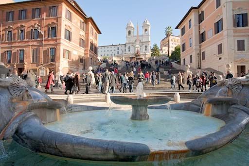 Fountain on Spanish square with Spanish Steps on background