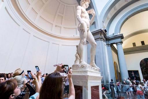 Tourists admiring the David inside the Accademia