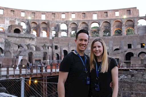 happy couple inside the colosseum at sunset