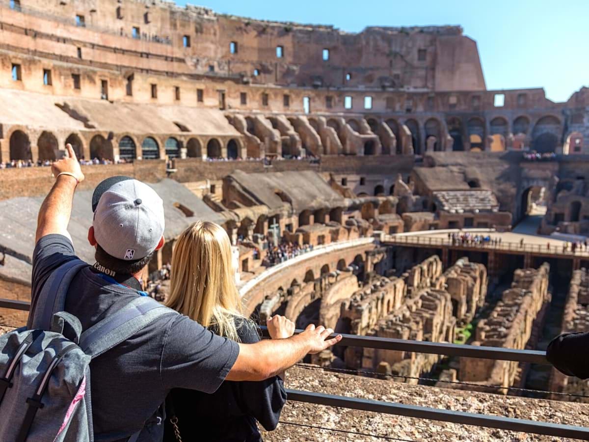 Couple admiring the ancient architecture of the Colosseum in Rome